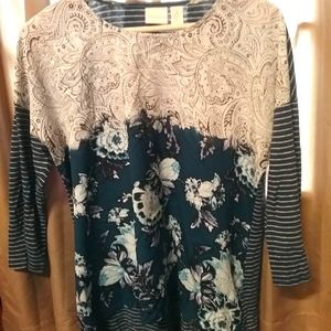 Chico's Jersey style shirt with three-quarter inch sleeves and Hi-Lo hem.